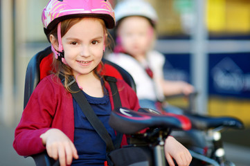 Obraz premium Two little sisters ready to ride a bike