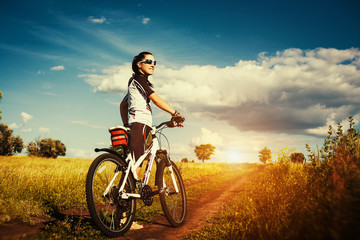 Young Woman is riding bicycle outside. Healthy Lifestyle