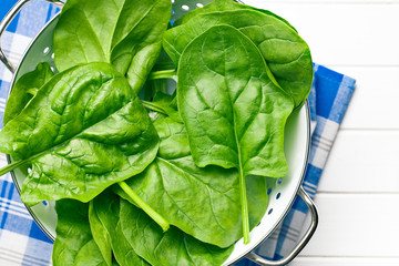 green spinach leaves in colander