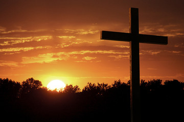 Dramatic Easter Sunrise With Bright Yelllow Sun and Large Cross