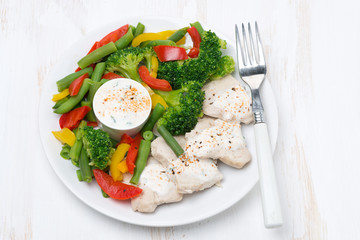 healthy food - chicken, steamed vegetables and yoghurt sauce