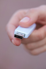 hand holding black USB data storage