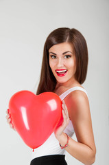 A beautiful woman with a balloon in the shape of a heart