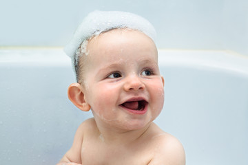 Happy baby boy in bath