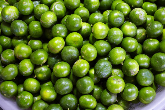 close up asian green lemon in market