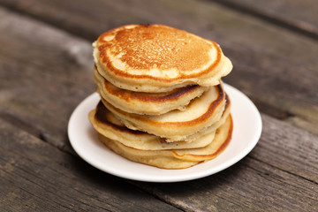 Fototapeta na wymiar Delicious pancakes on a wooden table