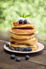 Delicious pancakes with blueberry and whipped cream