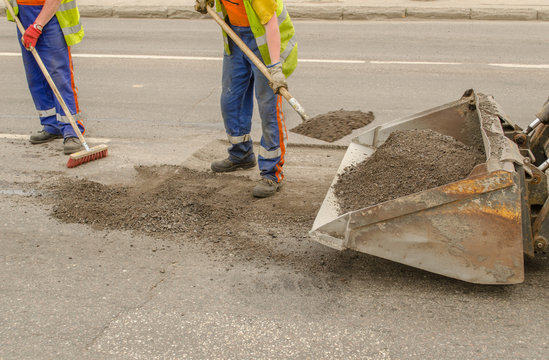 worker operating asphalt during road works