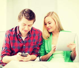 students using smartphone and tablet pc at school