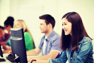 students with computers studying at school