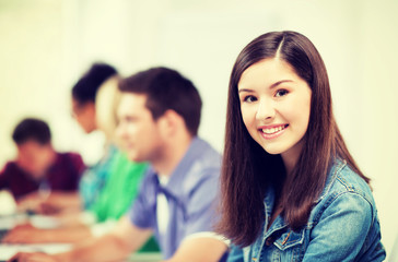 student with computer studying at school