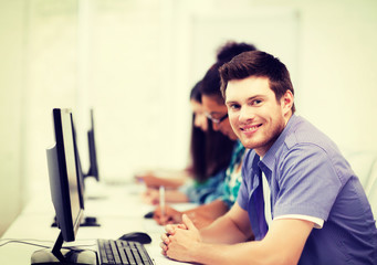 student with computer studying at school