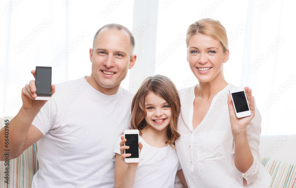 Poster parents and little girl with smartphones at home