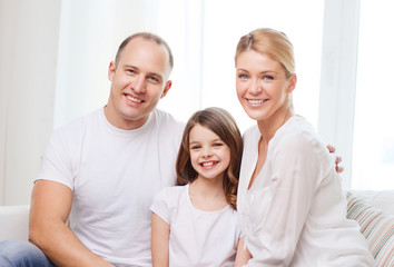Obraz premium smiling parents and little girl at home