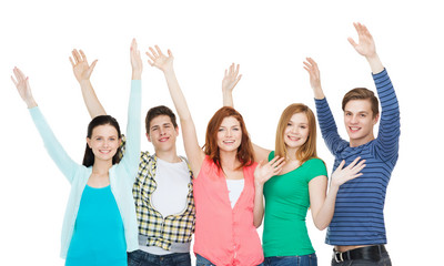 group of smiling students waving hands