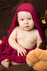 Baby girl wrapped in a red scarf