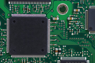 Green computer board with chips and components.