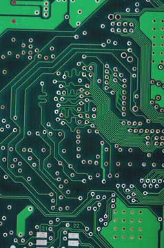 Green computer board with chips and components.