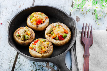 Baked mushrooms with cheese and vegetables
