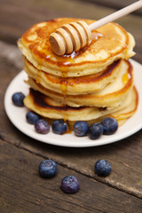 Delicious pancakes with blueberry and honey
