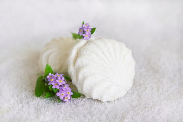 White marshmallow and forget-me-not on a white background