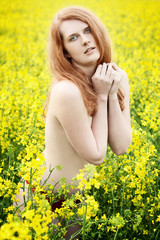 Naklejka na ściany i meble Beautiful naked redhead in a nature