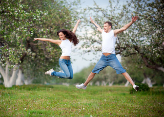 A shot of a happy couple jumping for joy