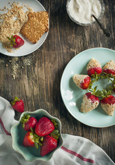 Fresh strawberry coated in yogurt and cookies crumble