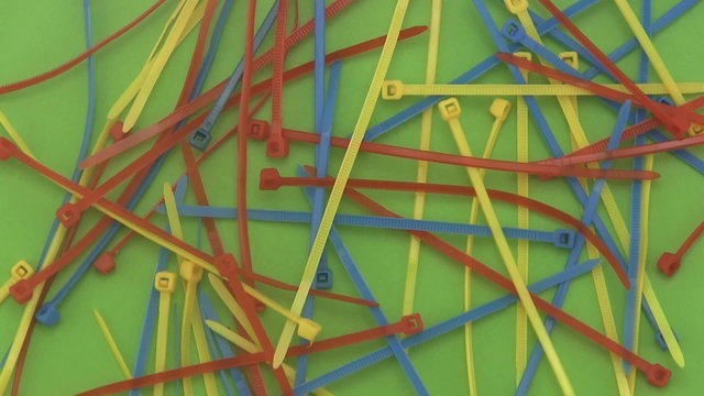 Cable ties or ny-lock on a green background.