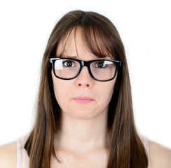 Fototapeta premium Portrait of sad young female isolated on white background