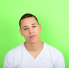Portrait of tired man against green background