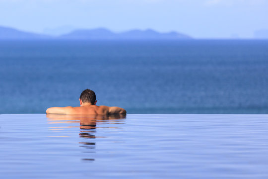 Man Relaxing in an Infinite Pool
