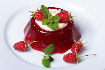 Tasty dessert raspberry jelly with mint and cream horizontal