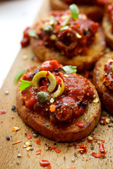 Crostini with roasted tomato salsa and olives
