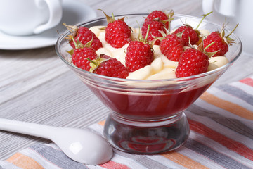 Tasty dessert of raspberries with cream and jelly in a glass
