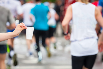 Marathon runner picking up water at service point