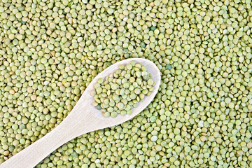 Lentils green texture with a wooden spoon