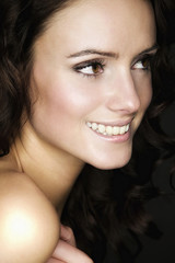 Obraz premium Beautiful young woman with long brown hair. Pretty model smiling