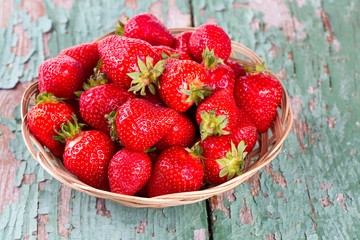 basket with strawberries on a wooden table