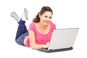 Girl lying on the floor and working with laptop