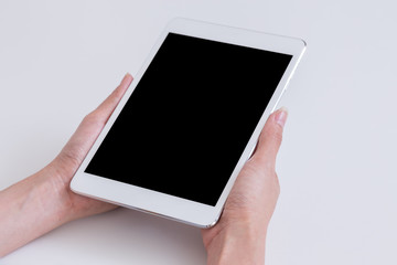 Women hands holding tablet computer with blank screen for advert