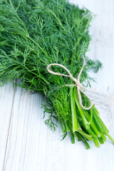 bunch of dill on wooden surface