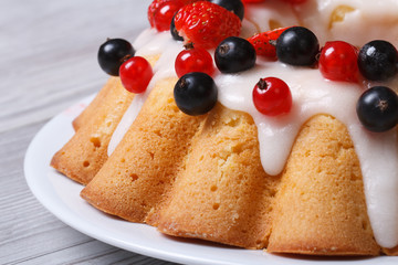 Festive fruit cake with icing and fresh berries macro horizontal