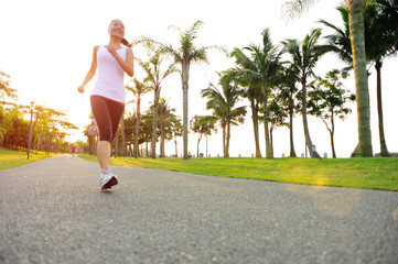 woman runner athlete running at tropical park