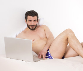 man in bed with laptop