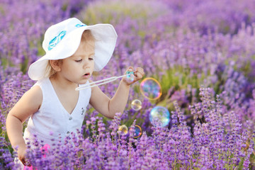toddler in field with bubbles
