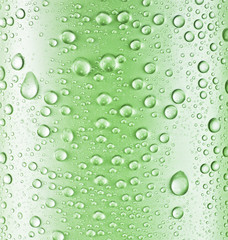 Water drops over green glass background.