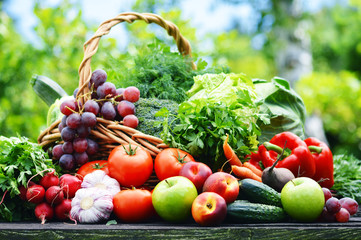 Fresh organic vegetables in wicker basket in the garden