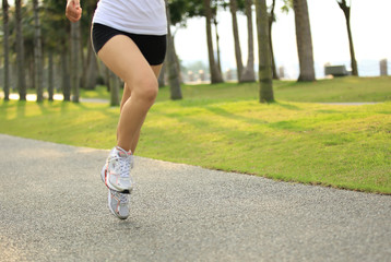 woman runner athlete running at tropical park