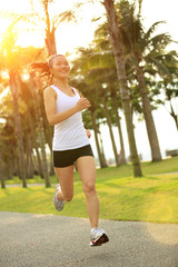 woman runner athlete running at tropical park